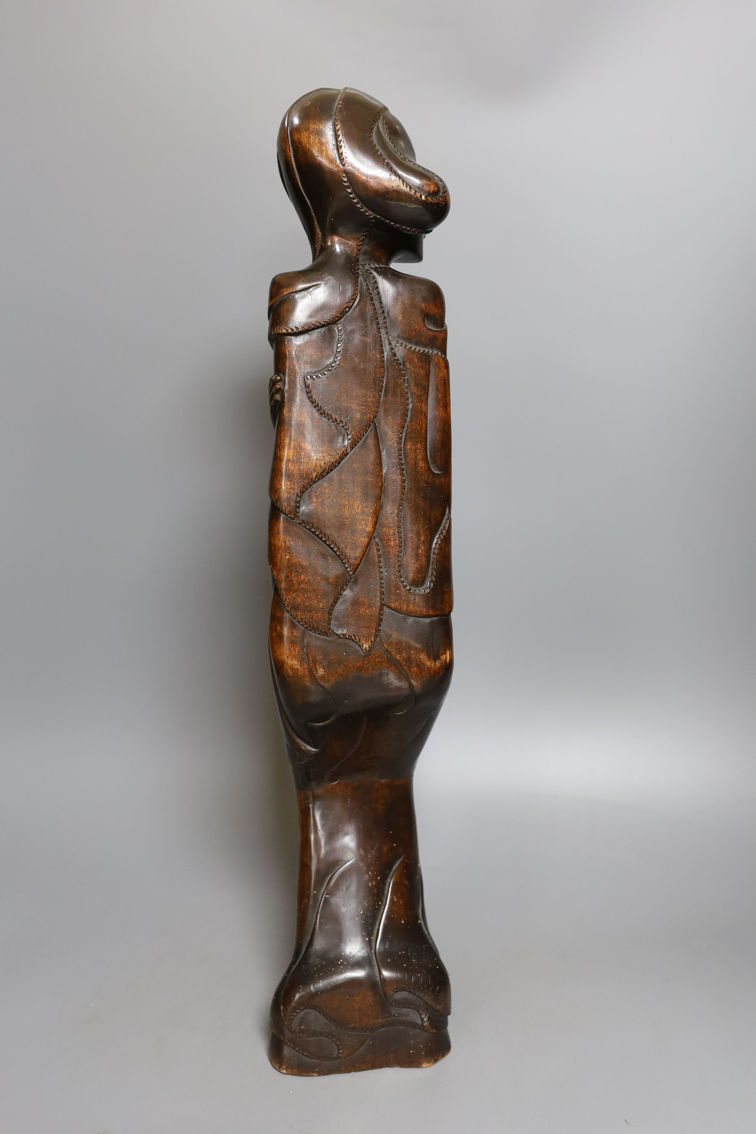 A Burmese carved hardwood figure, 51.5cm tall, and a Burmese horn and animal-bladder fan